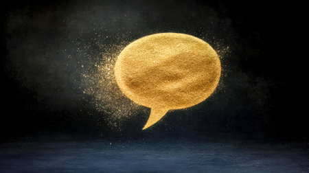 Golden speech bubble dissolving into dust on dark backgroundの素材