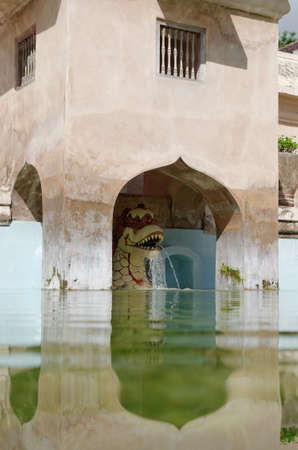 dragon fountain on the ancient pool at taman sari water castle - the royal garden of sultanate of jogjakartaの写真素材