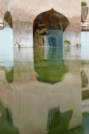 dragon fountain on the ancient pool at taman sari water castle - the royal garden of sultanate of jogjakartaの写真素材