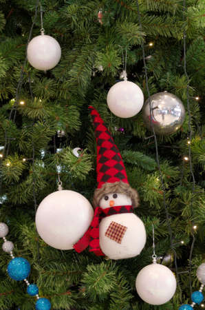 snowman ornament hanging on christmas a treeの写真素材
