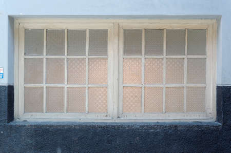 the old textured glass windowの写真素材