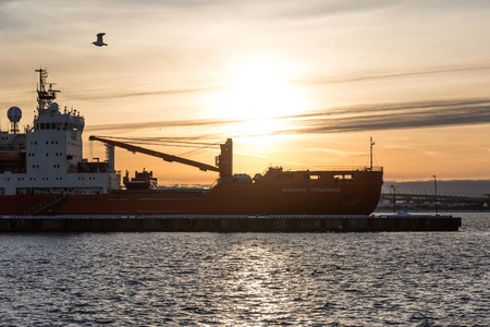 ST. PETERSBURG, RUSSIA - DECEMBER 07, 2017: Akademik Tryoshnikov, Russian scientific diesel-electric research vessel, the flagship of the Russian polar research fleet, at sunset time.のeditorial素材
