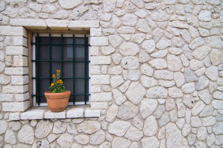 pot on the window on the wall of stonesの写真素材