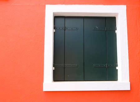 Red wall in Burano island, Venice, Italy