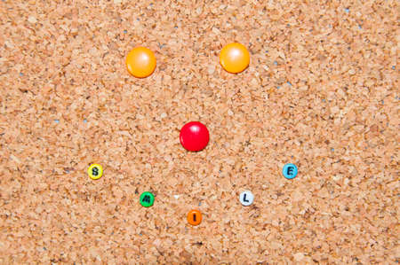 Colored smile face on cork backgroundの写真素材