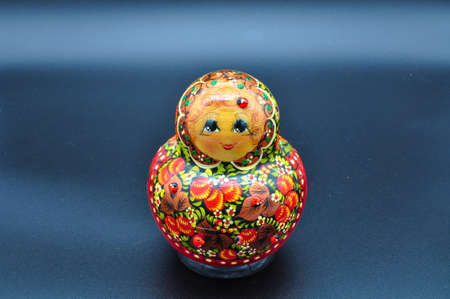 Happy red Russian original matryoshka with ladybugs isolated on black backgroundの写真素材
