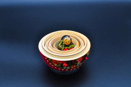 Happy red Russian original matryoshka with ladybugs isolated on black backgroundの写真素材
