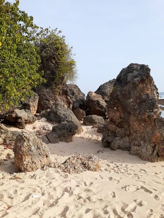 Rocks profile in the foreground. The ocean behind many stones along the coast.の写真素材