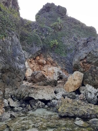 The cliff near coral reefs. The coastline at Siung beach with diversity of stone shapes.の写真素材
