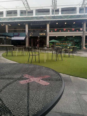 Bekasi, Indonesia - July 10, 2020: The X symbol is part of a table that is prohibited for use due to social distancing to prevent the spread of coronavirus. Inside the empty cafe mall.のeditorial素材