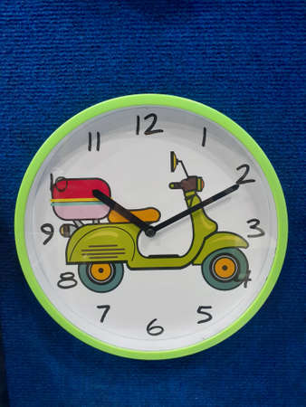 Cartoon scooter style wall clock. Wall clock decoration on blue background.の写真素材