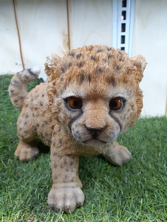 Statuary baby leopard on the grass.の写真素材