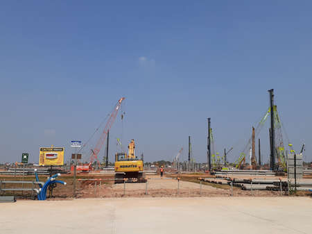 Heavy construction equipment at the project site. The power plant project with a capacity of 1760 Mega Watt (MW), located in Karawang, West Java.のeditorial素材