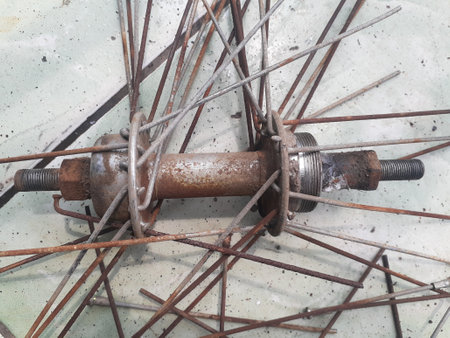 Old rusty bicycle wheel in a workshop, close-up of photo.の写真素材