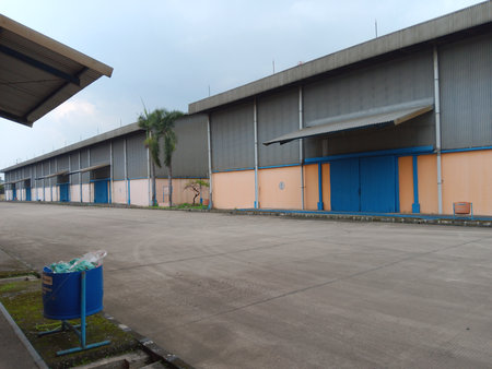 Parking lot with blue doors and orange walls in warehouse.の写真素材