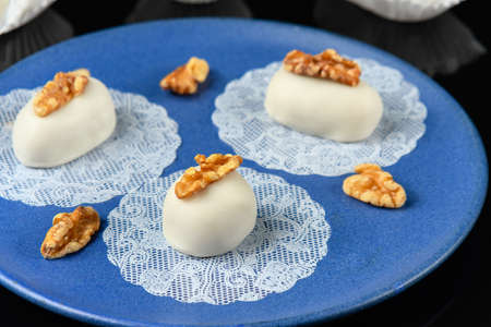 sweet walnut cameo on a blue ceramic plate seen at 45 degrees