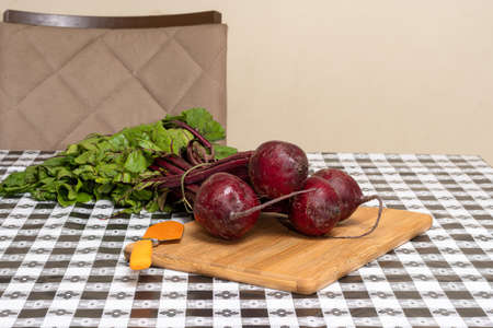 ORGANIC BEET ON A TABLE WITH BLACK AND WHITE PLAID TOWEL