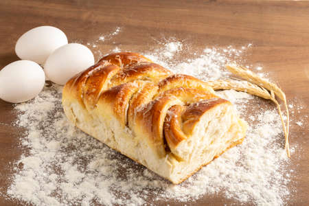 braided bread decorated with grated coconut, eggs and wheat branch,