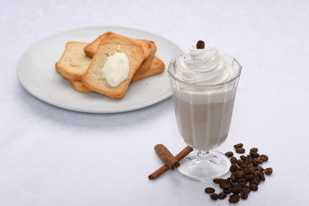 Coffee with cream and crackers on a white background.の写真素材