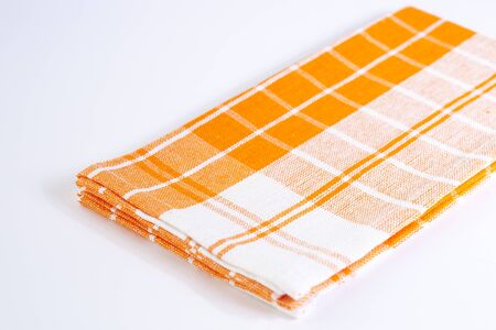 Kitchen rag of orange color on a white bottomの写真素材