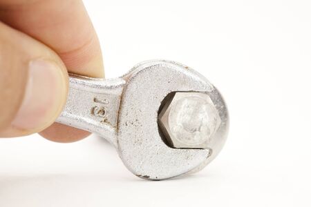 Worker tightening a screw with white background