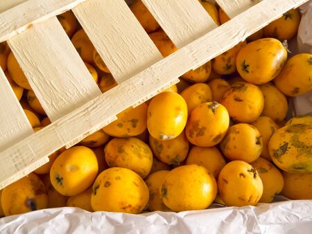 Wooden box with a selection of quality medlar