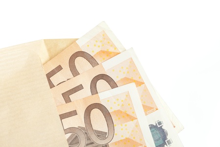 Fifty euro notes stuffed into a brown envelopeの写真素材