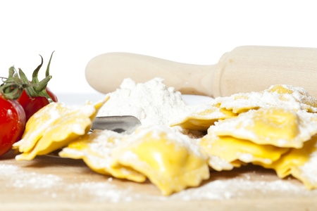 Elaboration of delicious fresh cheese ravioli with tomatoの写真素材