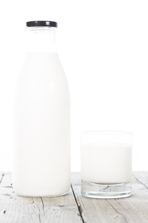 Bottle and glass of milk on white backgroundの写真素材