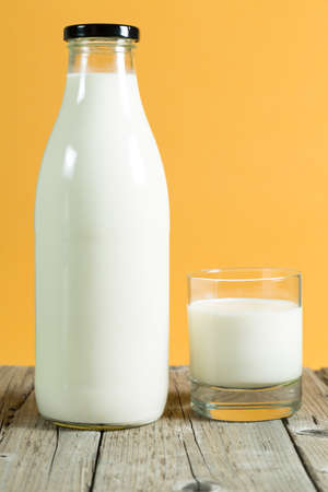Milk bottle on a table with color backgroundの写真素材