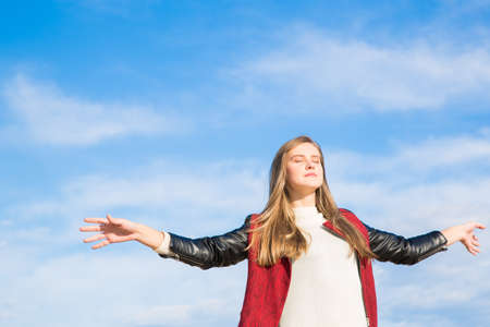 Girl breathing deeply at the beach on a sunny dayの写真素材