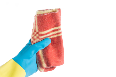 Hand with glove and a cloth cleans dust