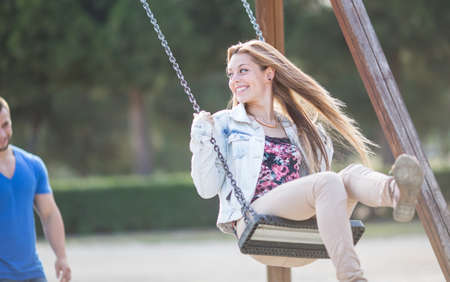 Man swinging his girl in a parkの写真素材
