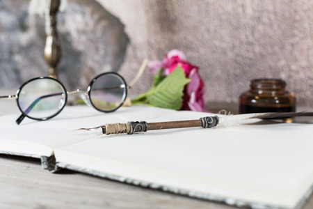Table desk with an old pen and candle