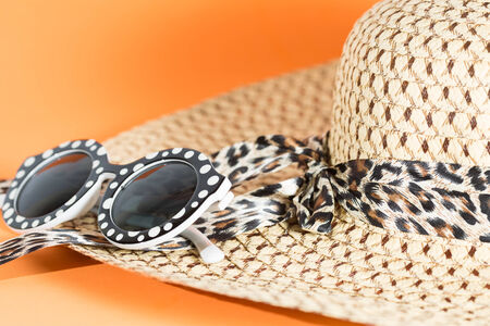 Beach hat and sunglasses with blue backgroundの写真素材
