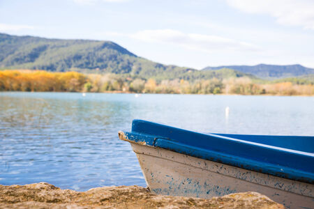Boat in a lake on a cold autumn dayの写真素材