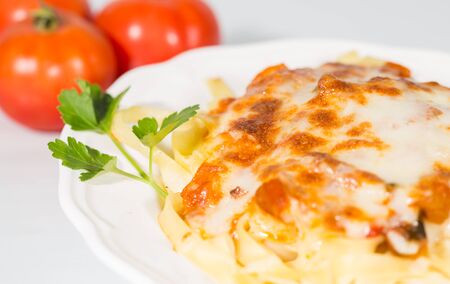 Noodles topped with tomato sauce and grated cheeseの写真素材