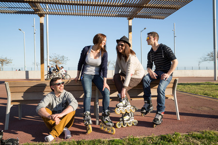 Meeting friends laughing skating on a spring afternoonの写真素材