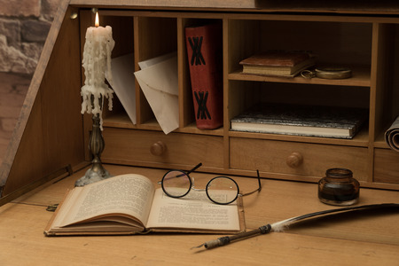 Antique desk with his pen and old booksの写真素材