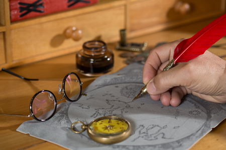 Adventurer drawing a map in search of a lost treasureの写真素材