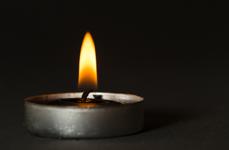 Black candle with black backgroundの写真素材
