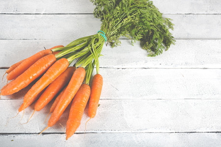 Delicious fresh carrots on a vintage tableの写真素材
