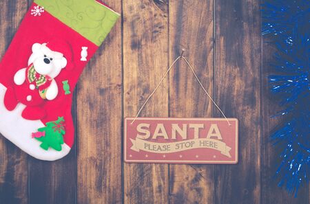 Santa Claus poster next to sock giftsの写真素材