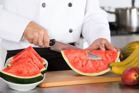 Chef cutting a delicious sweet watermelonの写真素材