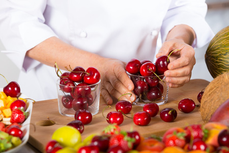 Chef preparing some jars with delicious cherriesの写真素材