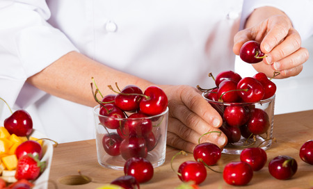 Chef preparing some jars with delicious cherriesの写真素材