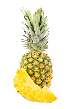 Natural pineapple with cut up pieces and white backgroundの写真素材