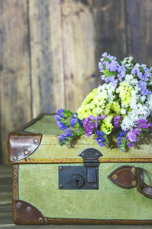 Old travel bag with delicate flowersの写真素材