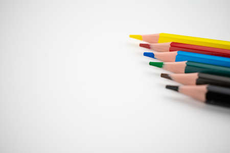 Notepad with a white sheet on a yellow background. Man's hand tries to write.