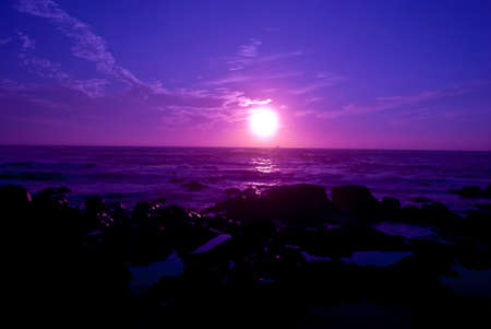 view of the sea horizon at sunset and silhouette of a shipの写真素材